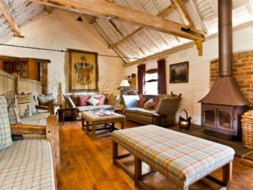 a living room filled with furniture and a fireplace at Old Downton Lodge in Downton