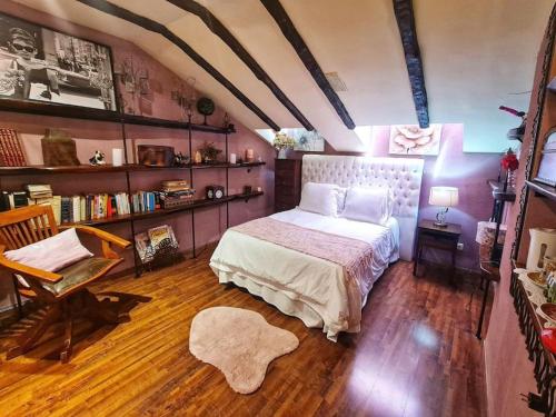 a bedroom with a bed and a book shelf at Atico 3 dormitorios Ron Manuel Marbella Centro in Marbella