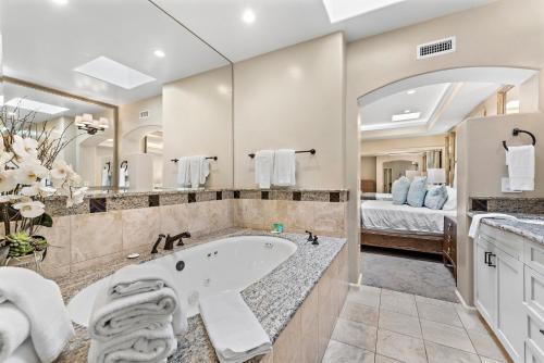 a large bathroom with a tub and a bedroom at Laguna Villa in Laguna Beach