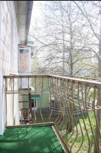 a balcony of a house with a green floor at Квартира in Bender
