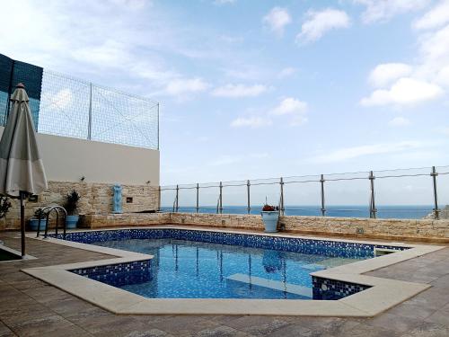a swimming pool with the ocean in the background at Korfe Estate in Fodele