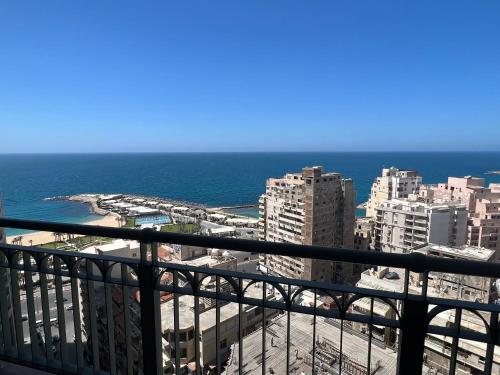 a view of the ocean from the balcony of a building at Luxurious Grand plaza in Alexandria