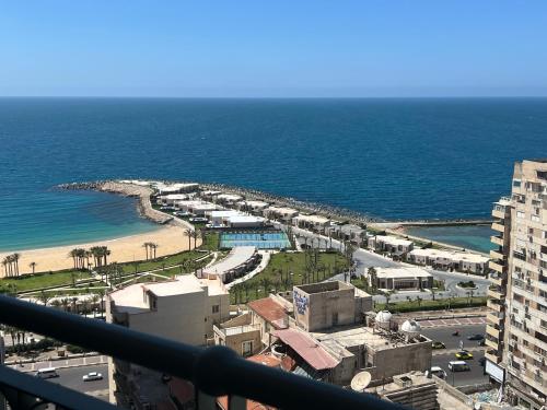 a view of a beach and the ocean from a building at Luxurious Grand plaza in Alexandria