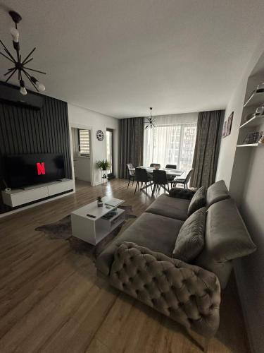 a living room with a couch and a table at Citta luxury apartment 75 in Bucharest