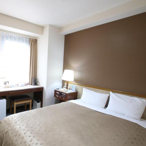 Postel nebo postele na pokoji v ubytování Hotel Aston Hotel Osaka Sakai
