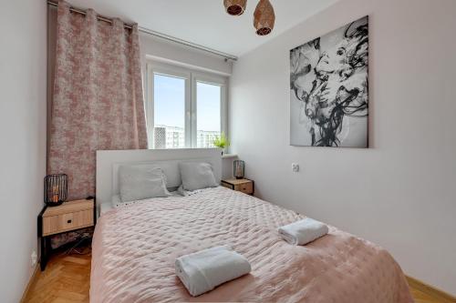 a bedroom with a large bed with two pillows on it at Platinium Apartament Morski in Gdańsk