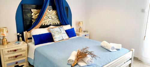 a bedroom with a blue bed with a blue canopy at Blue Siri Apartment in Heraklio