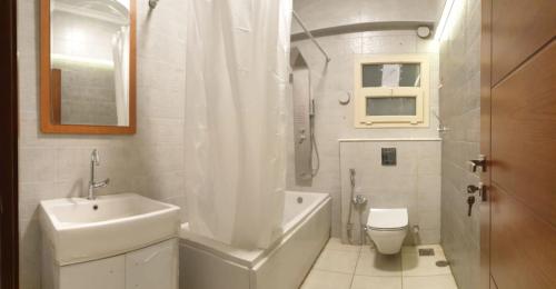 a white bathroom with a sink and a toilet at Beautiful semi villa with private entrance in Sheikh Zayed- villa queen in Sheikh Zayed