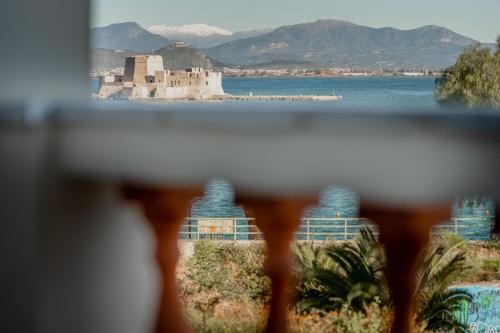 a view from a balcony of a castle on the water at Impero Nafplio Hotel & Suites in Nafplio