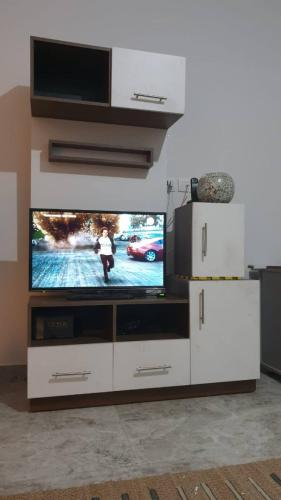 a large white entertainment center with a television on it at Beautiful semi villa with private entrance in Sheikh Zayed- villa queen in Sheikh Zayed