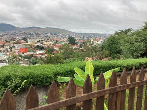 a wooden fence with a view of a city at Villa ChezSoa, Antananarivo in Antananarivo