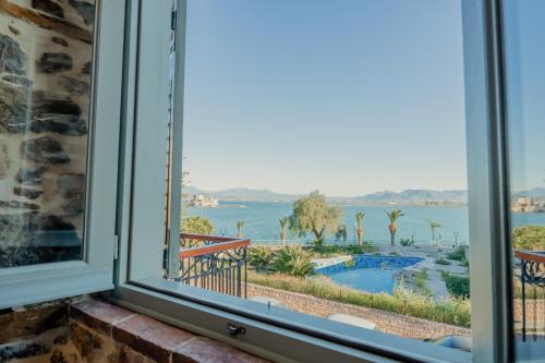a window with a view of the water at Impero Nafplio Hotel & Suites in Nafplio