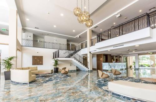 a living room with a staircase and a lobby at Hope Harbour Hotel in Gold Coast