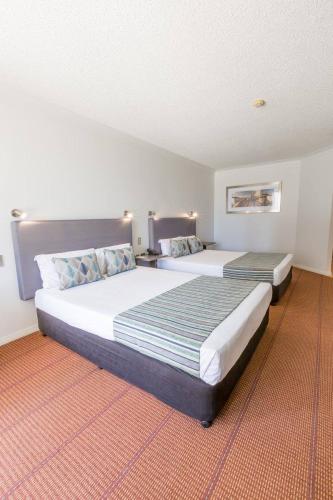 a hotel room with two beds in a room at Hope Harbour Hotel in Gold Coast