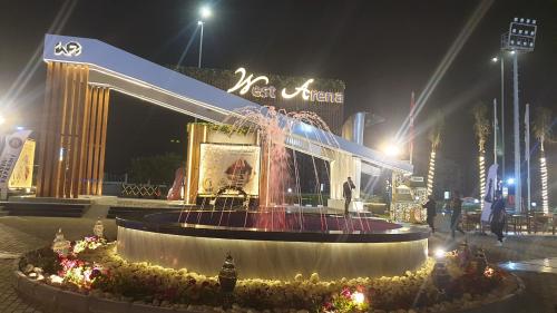 a fountain in front of a building at night at Beautiful semi villa with private entrance in Sheikh Zayed- villa queen in Sheikh Zayed