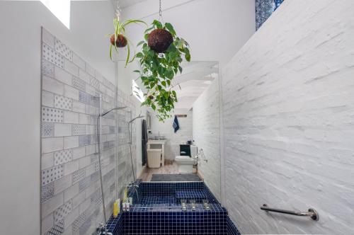 a bathroom with a toilet and blue tiles at The Earthy Inn in Greyton