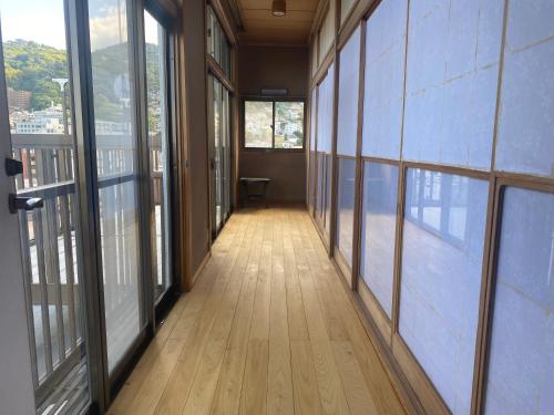 an empty hallway in an office building with windows at ヴィラマーレ熱海（Villa Mare Atami） in Atami