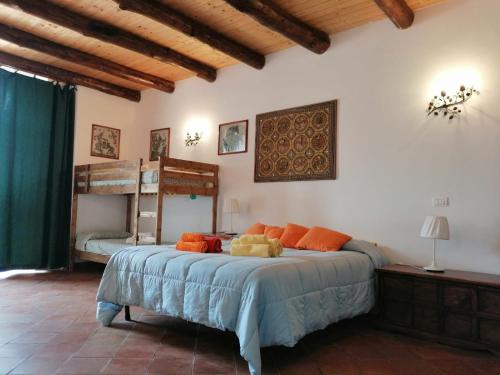 a bedroom with a bed and two bunk beds at Antico Casale dell'Etna in Puntalazzo