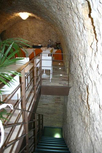 a hallway with a staircase leading up to a room with a table at Antico Borgo Chieti in Chieti