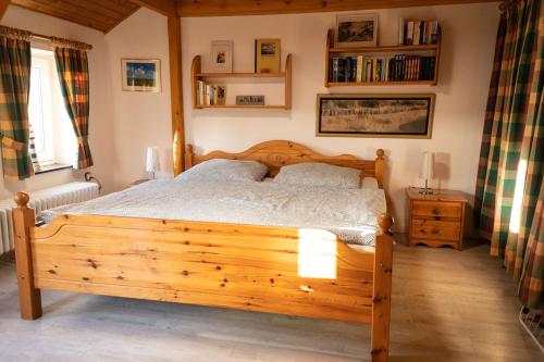 a bedroom with a wooden bed in a room at Sophienmühle I Nähe Carolinensiel in Wangerland