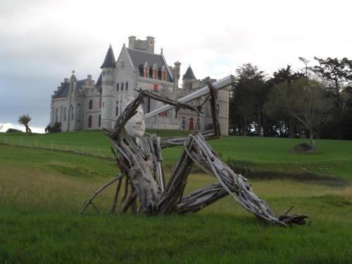 a sculpture in the grass in front of a castle at Campanile Hendaye in Hendaye