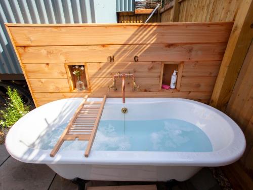 a bath tub with a ladder on top of it at Spindleberry Hut in Dorchester