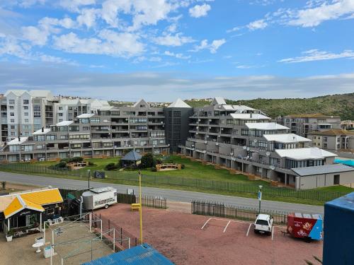 a group of apartment buildings with a parking lot at Diaz De Valle 35 in Mossel Bay