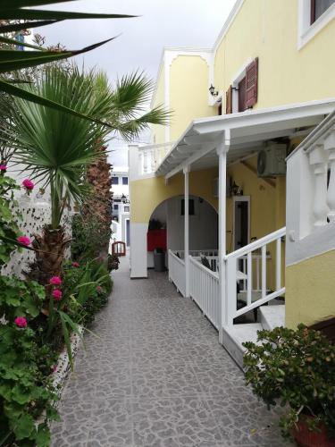 a walkway leading to the front of a building at Christina Pension in Karterados