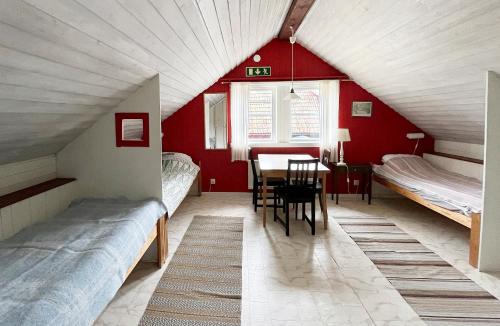a room with two beds and a table in it at STF Tivedstorp in Tivedstorp