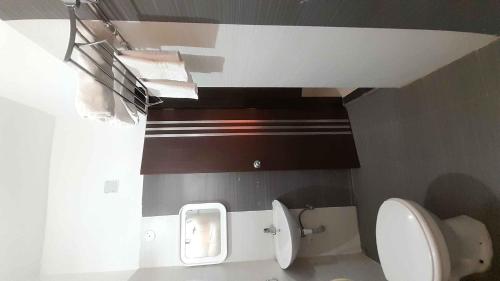 a bathroom with a toilet and a sink at Sublime Homestay in Bhubaneshwar