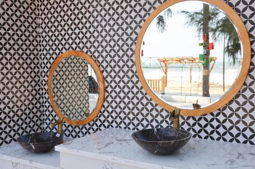 two bowls on a counter in front of a mirror at Trân Châu Beach & Resort in Ba Ria