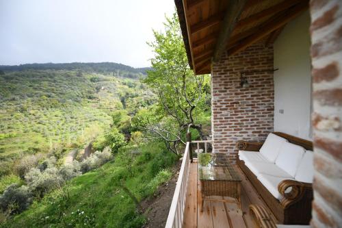 a white couch sitting on a balcony with a view at Nisanyan Hotel in Selcuk