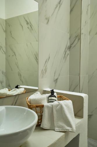 a white bathroom with a sink and a mirror at Mea Terra Villas in Lachania