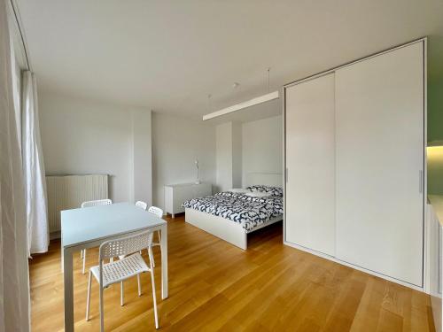 a bedroom with a bed and a table and chairs at Elegant Apart-800m Main Square-Parking and lift in Wrocław