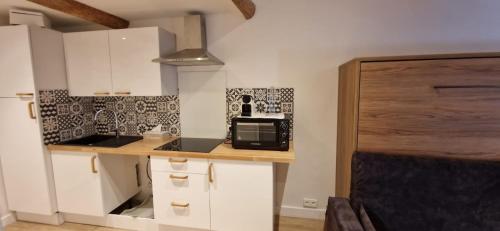 a small kitchen with a counter with a microwave at Vieux Nice a 2min de la mer in Nice