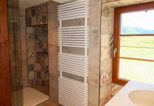 a bathroom with a white shelf in a shower at Villa de 5 chambres avec piscine privee jardin amenage et wifi a Saint Maime in Saint-Maime