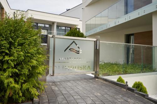 a sign in front of a building at Olimpijska by RENT4YOU in Olsztyn