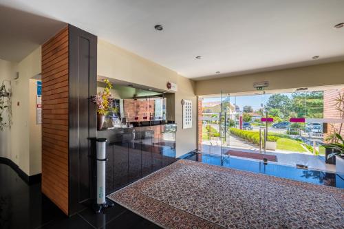 a lobby with a view of a building at Hotel Colmeia in Monte Real