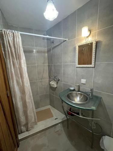 a bathroom with a sink and a shower at Secluded cottage w pool, oceanside view, 3BR, 3BA in Ponta do Sol