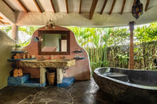a bathroom with a large sink and a tub at Casa Mila - 4BR Luxury Villa 5 Min from Canggu Beach in Canggu