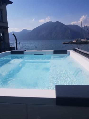 a large swimming pool with a view of the water at Araba Fenice Hotel in Iseo