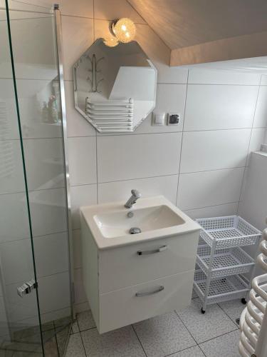 a bathroom with a sink and a mirror at Hacjenda - domek całoroczny in Krasnobród