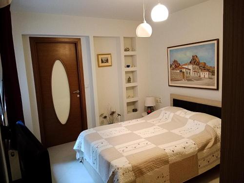a bedroom with a bed and a mirror and a door at Korfe Estate in Fodele