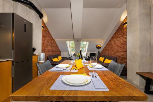 a dining room with a wooden table with plates on it at Industrial-style 2BD Loft with Parking Spot in Plovdiv