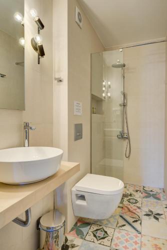 a bathroom with a sink and a toilet and a shower at Gambello Luxury Rooms in Nafplio