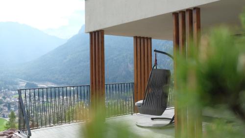 a balcony with a chair and a view of mountains at Runk Apartments in Siusi