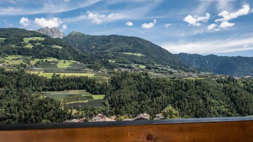 a view of a valley with trees and mountains at Hotel Zirmerhof & Residence in Rifiano