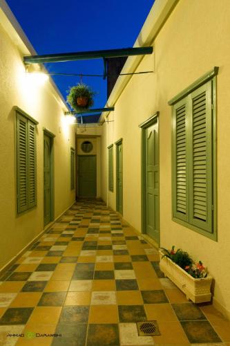 an empty hallway of a building with a checkered floor at Al-Hakim Boutique Hotel Old Town Nazareth in Nazareth