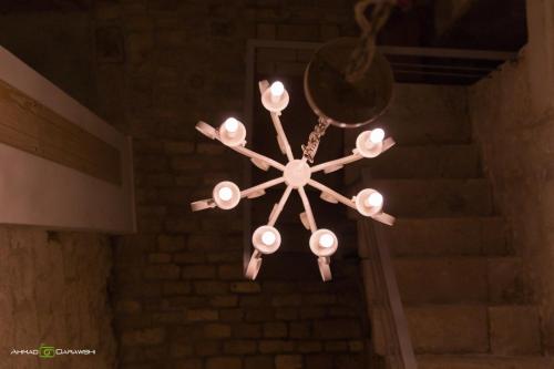 a chandelier hanging from the ceiling in a room at Al-Hakim Boutique Hotel Old Town Nazareth in Nazareth