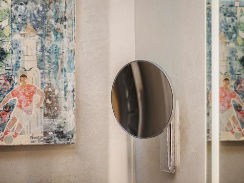 a mirror on a door with pictures on the wall at monas home mayrhofen in Mayrhofen